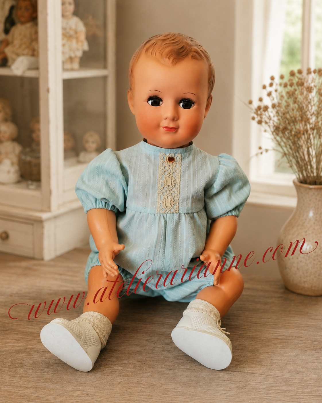 Visage du baigneur Petitcollin après restauration des cils, du maquillage et des cheveux peints par la clinique de poupées Atelier Arianne